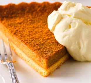 A slice of classic pumpkin pie and ice cream