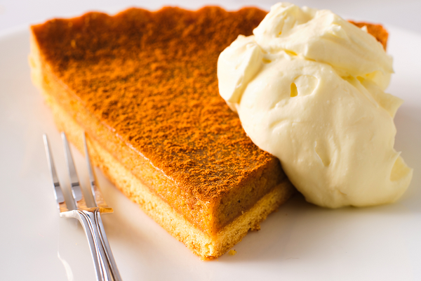 A slice of classic pumpkin pie and ice cream