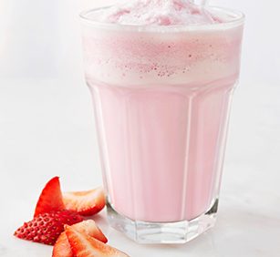 A glass of strawberry milkshake